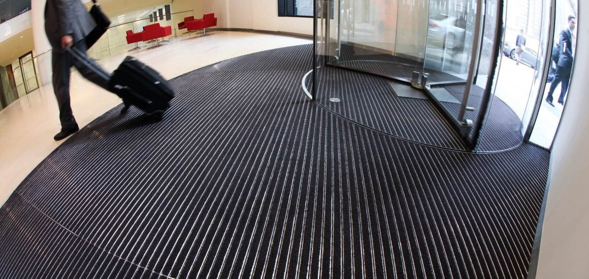 Pucture showing a man walking across Entrance Matting at Bartholomew Lane