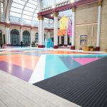 Image Showing colourful flooring and black Entrance Matting