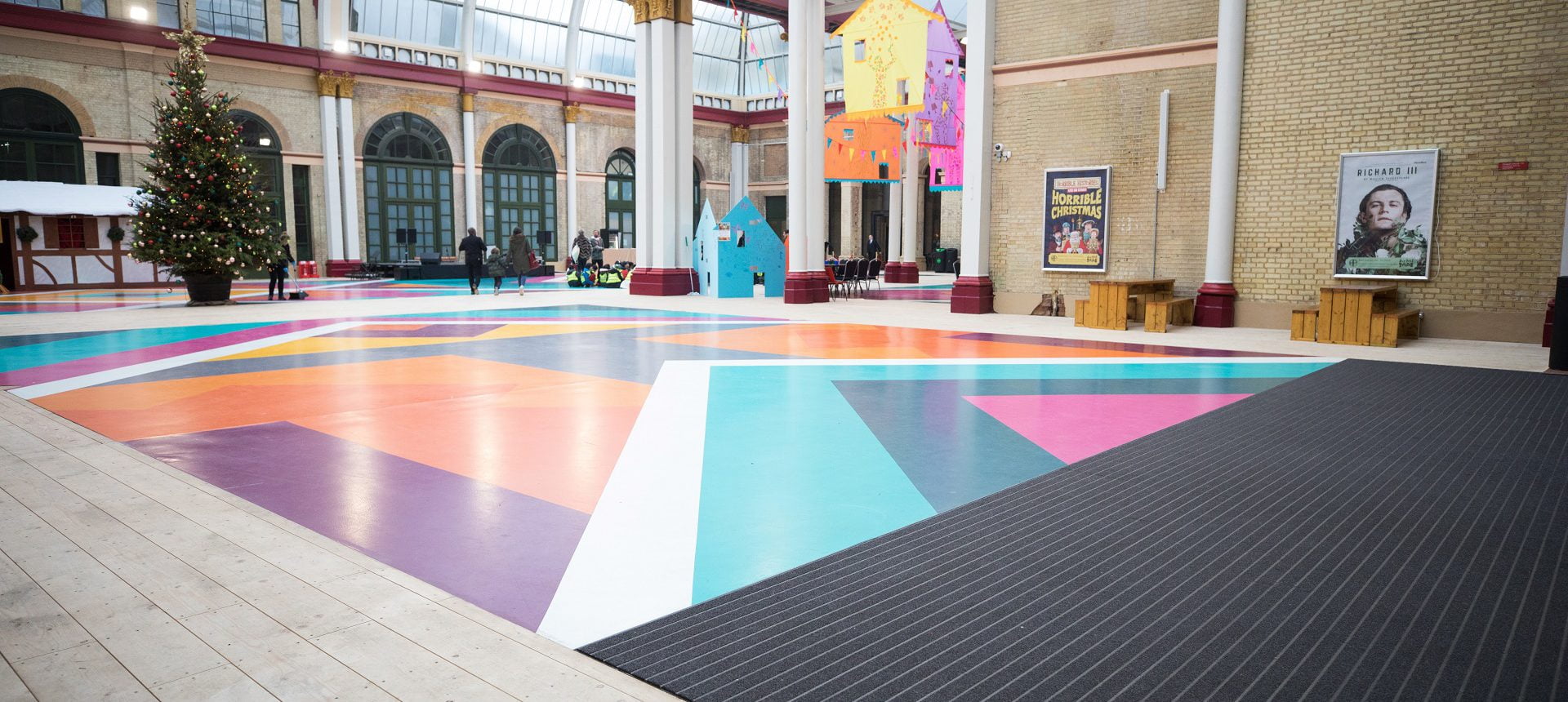 Image Showing colourful flooring and black Entrance Matting