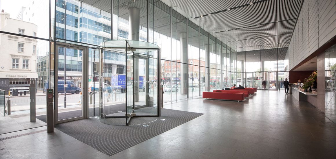 image showing a large reception of a commercial office building and a revolving door