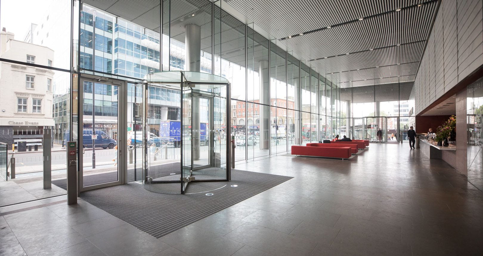 image showing a large reception of a commercial office building and a revolving door
