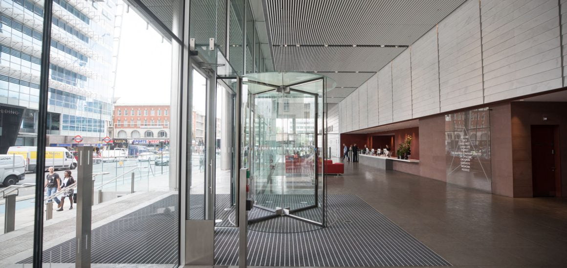 Image showing the revolving door with grey entrance matting at a commercial office building