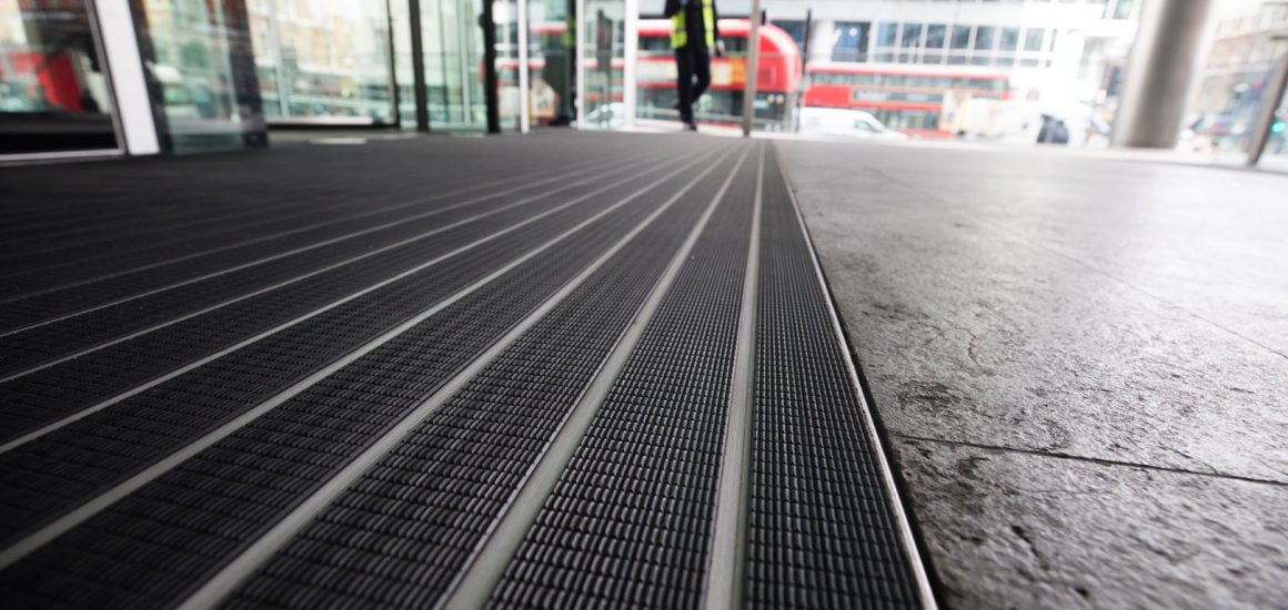 Image showing a close up of rubber matting at the entrance of a commercial office building.