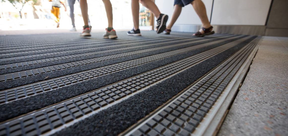 Image showing people walking over rubber and fibre Entrance Matting