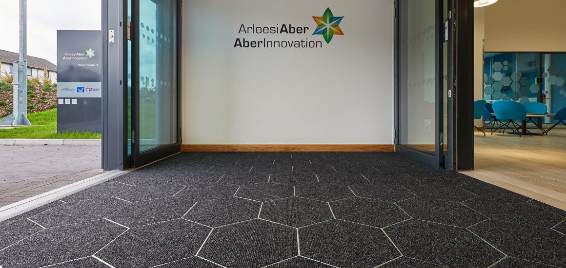 Unique hexagon entrance matting tiles echo the AberInnovation brand